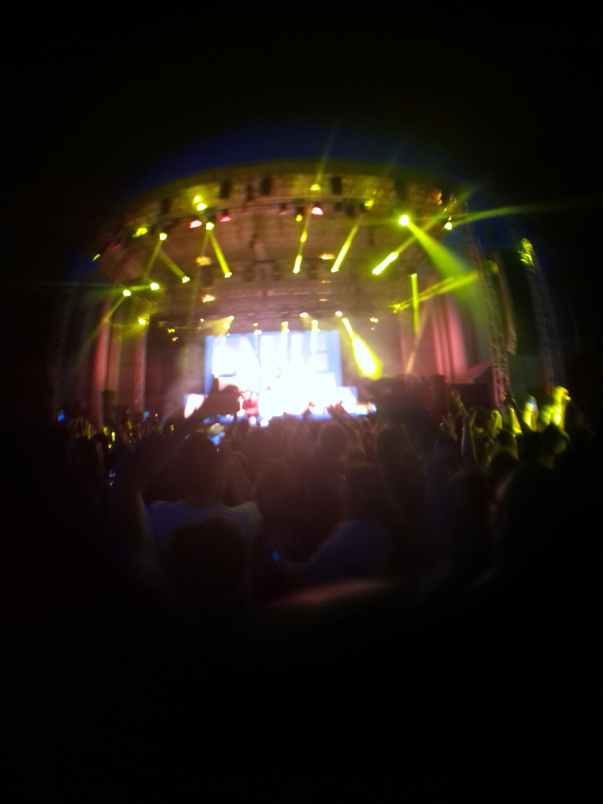 Concert stage with coloured lighting and crowd silhouettes - K-pop music tourism in Seoul