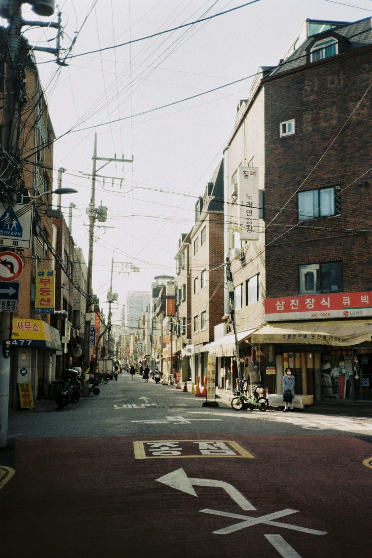 Local street scene in Seoul with Korean signage and brick buildings - Seoul neighbourhood guide