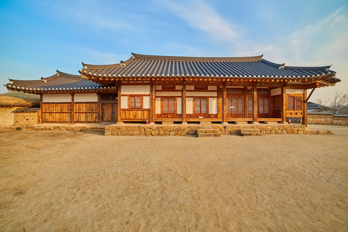 Traditional thatched-roof hanok houses along a river bend in Andong's Hahoe Village, South Korea