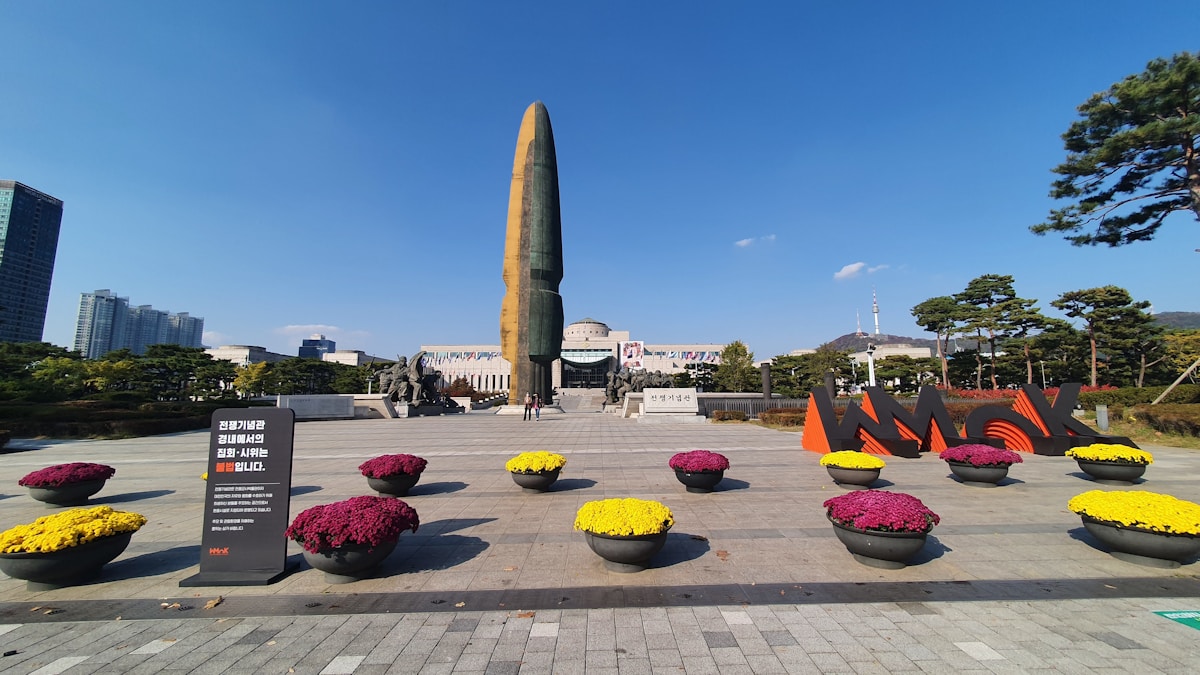 Large Korean memorial monument with flowers in front, South Korea