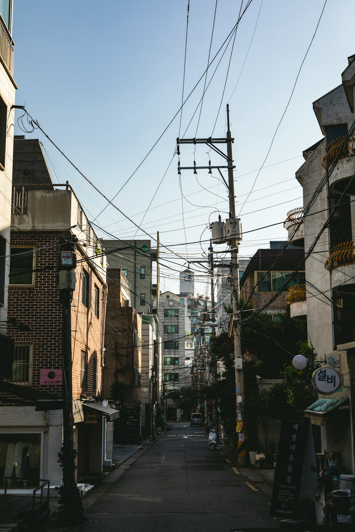 City street lined with buildings and Korean signage in South Korea