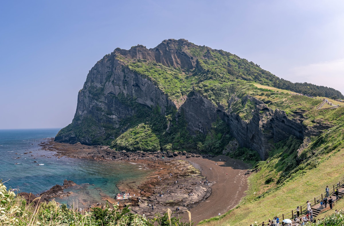 Seongsan Ilchulbong volcanic crater rising from the ocean on Jeju Island, South Korea