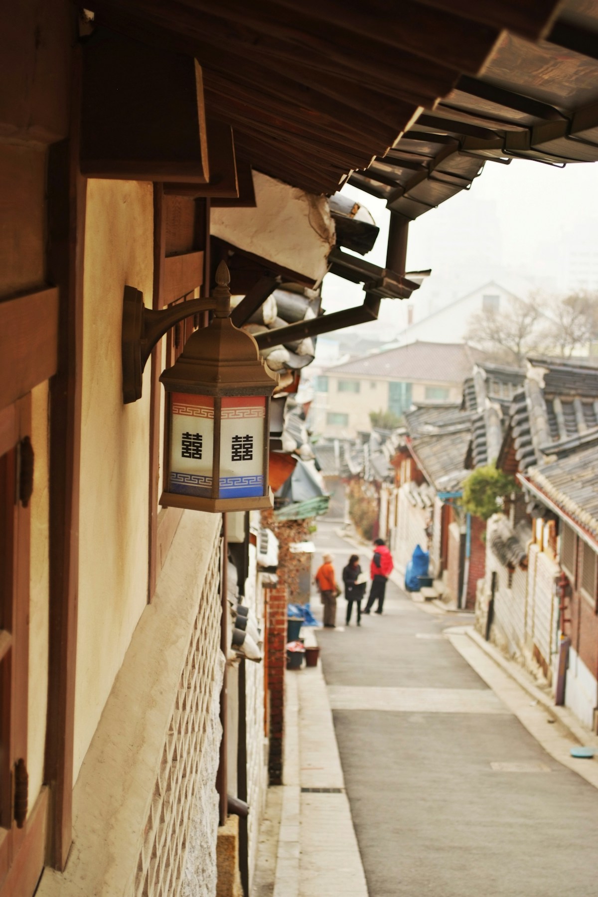 Traditional tile-roofed hanok houses lining Jeonju Hanok Village's main street at dawn