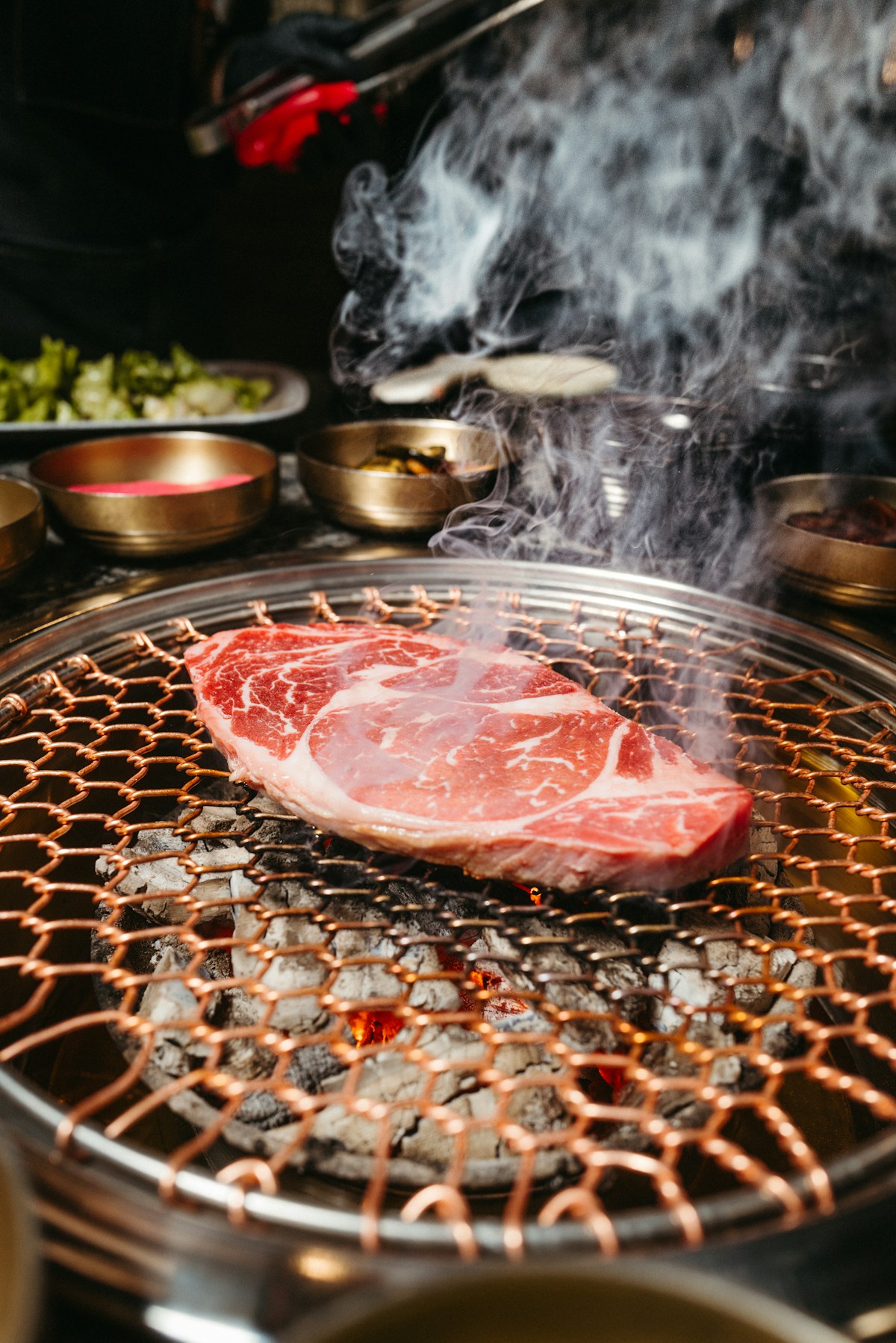 Korean barbecue with pork belly and side dishes on a table grill in Seoul