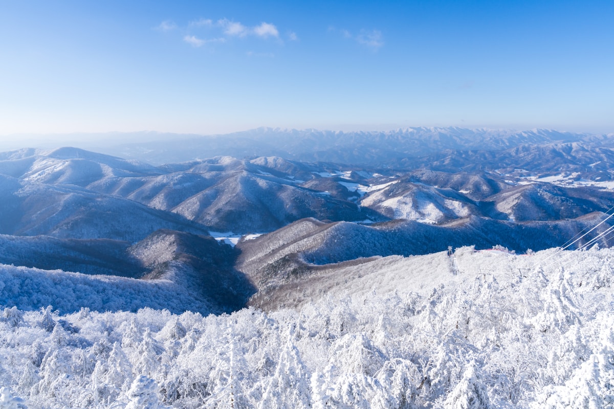 Snow-covered mountain panorama viewed from a Korean ski resort peak in winter