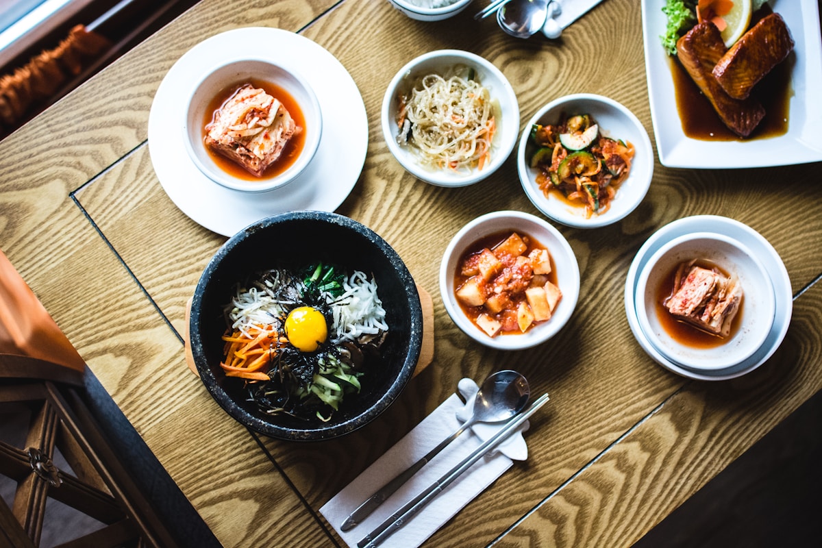 Charcoal grill with Korean BBQ meat and banchan side dishes on a restaurant table in Seoul