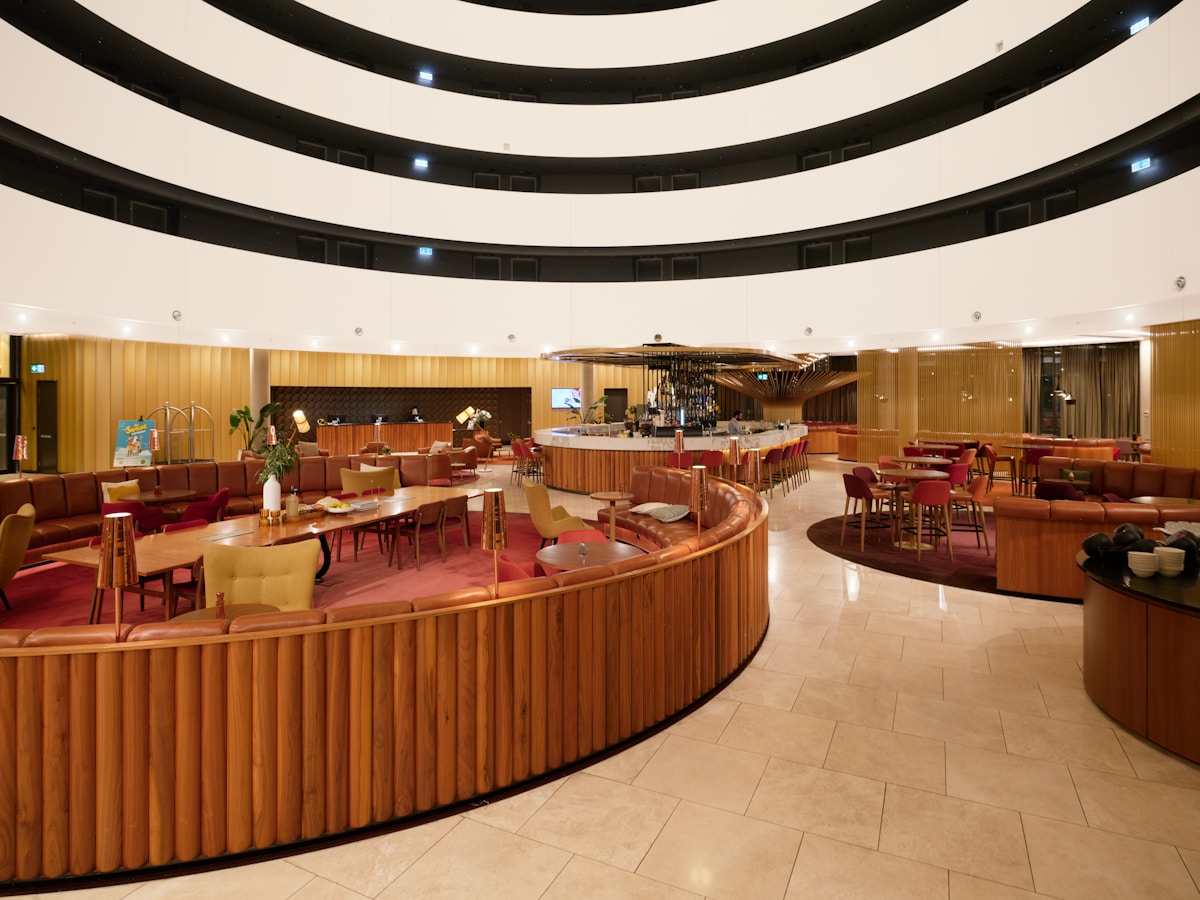 Modern hotel lobby in Seoul with floor-to-ceiling windows overlooking the city