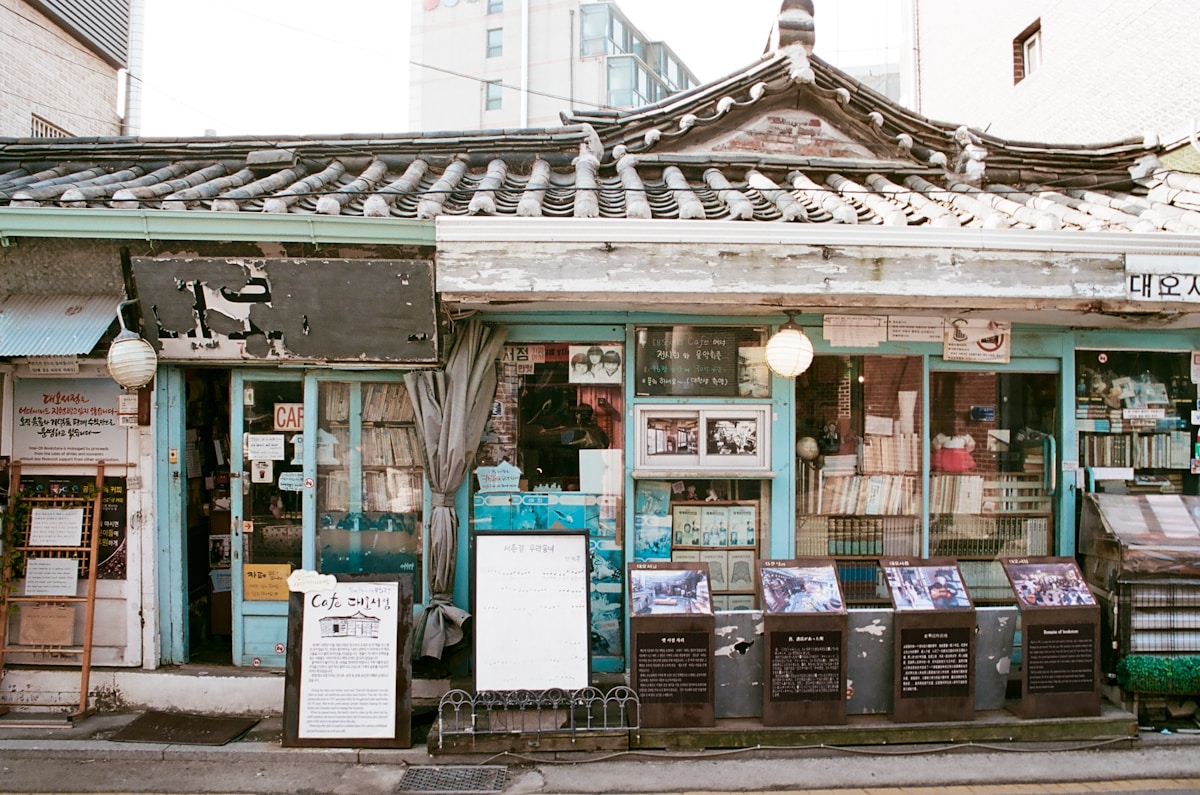 Traditional Korean cafe storefront in Seochon, Seoul with hanok roof tiles and displays