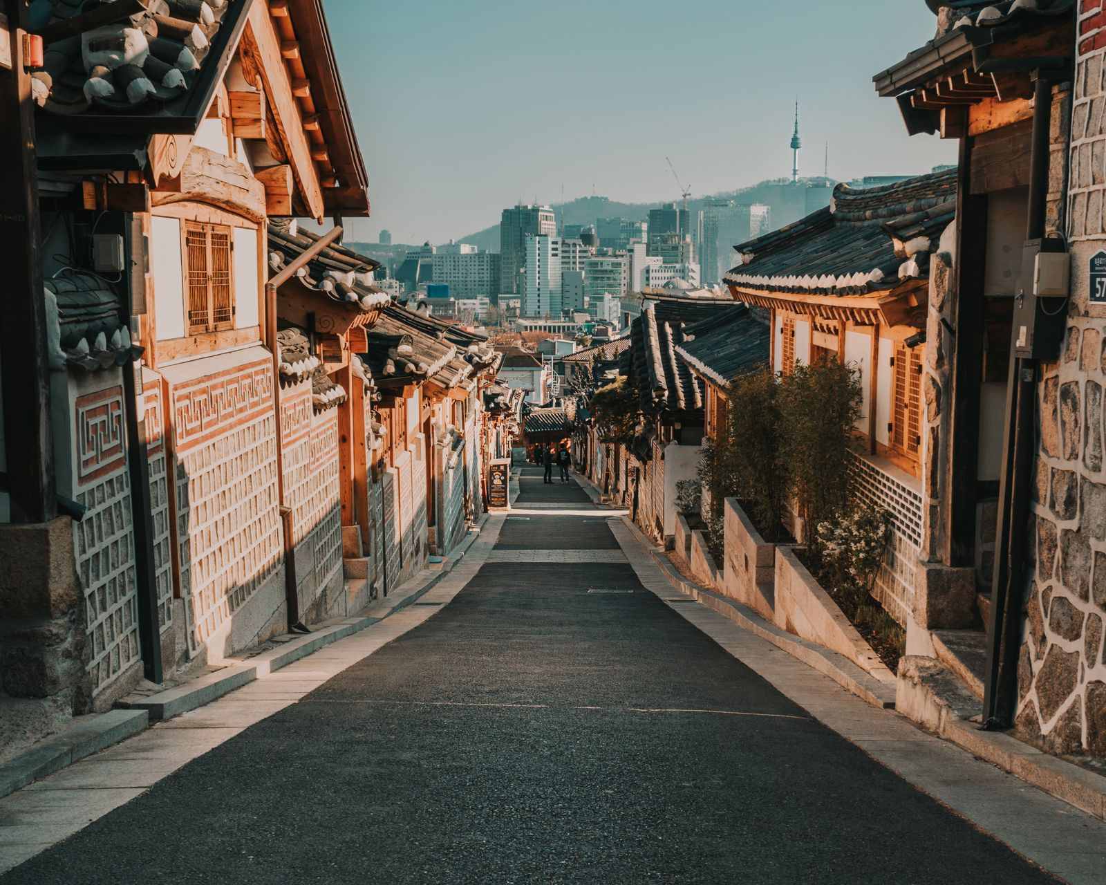 Traditional Korean hanok architecture with tiled roofs and spring cherry blossom, Ikseon-dong Seoul