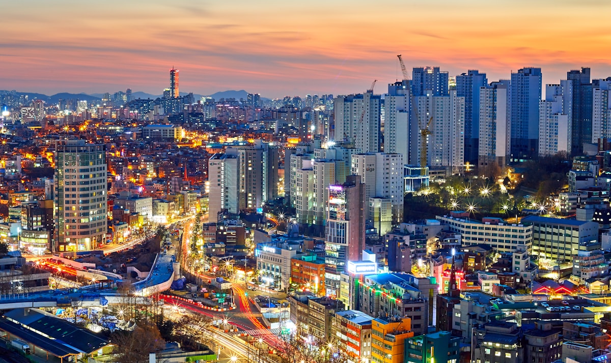 Aerial view of Seoul city high-rise buildings lit up at dusk, South Korea