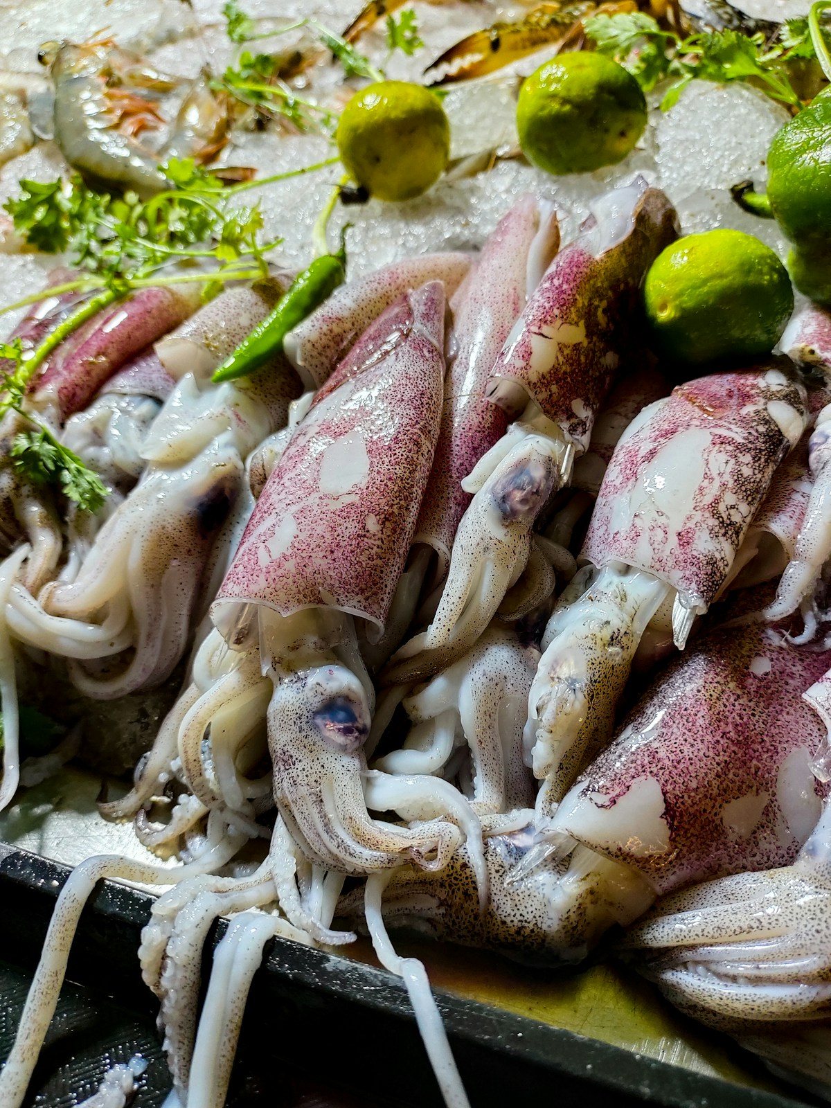 Plate of snow crab legs with dipping sauce on a wooden table at a Sokcho port restaurant