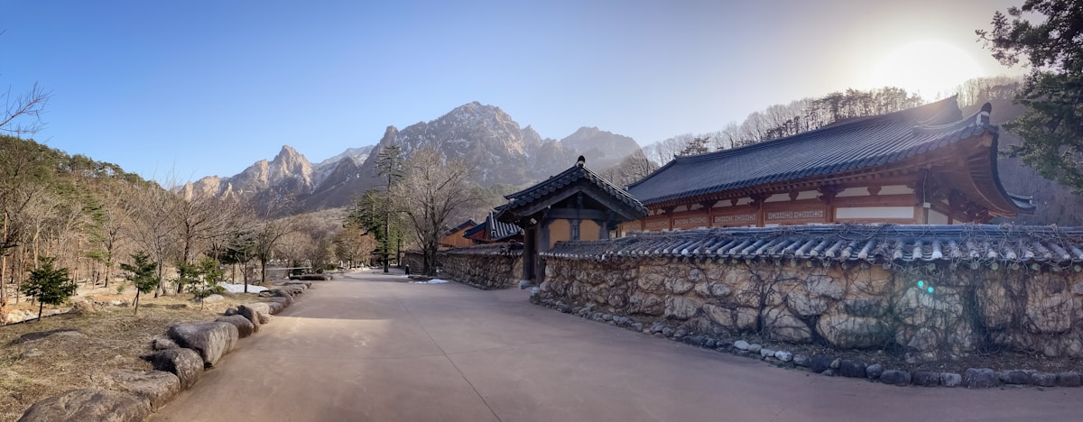 Traditional temple building with stone wall below Seoraksan mountain peaks, Sokcho area, South Korea
