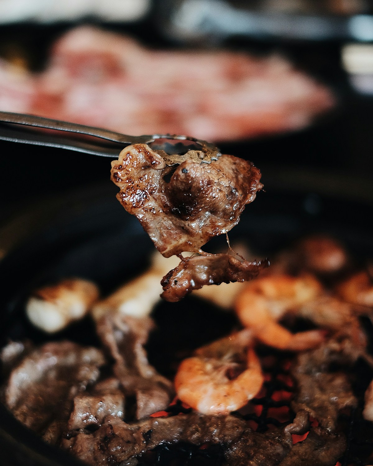Grilled galbi short ribs on a charcoal grill at a traditional Korean BBQ restaurant in Suwon
